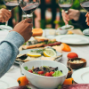 group of people with wine glasses and food